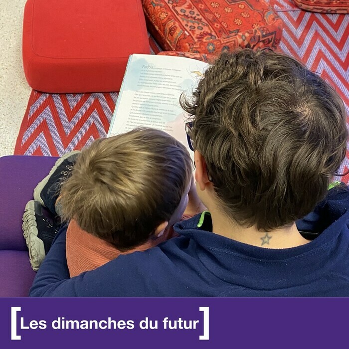 Un adulte et un enfant lisent ensemble un livre. Photo de dos.