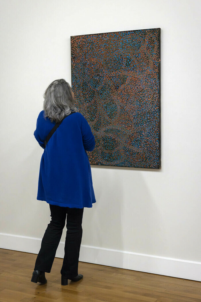 Photo de personnes devant une oeuvre de l'exposition