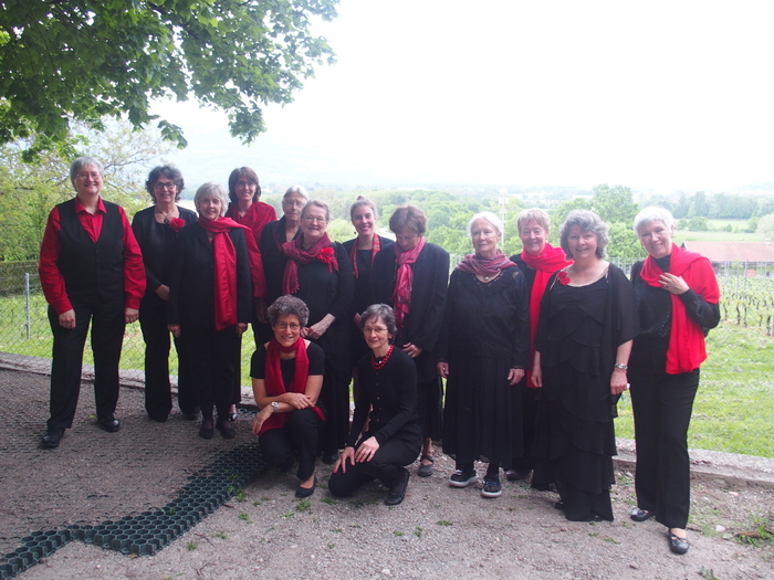 Choeur féminin, toutes les chanteuses sont habillées en noir et rouge.