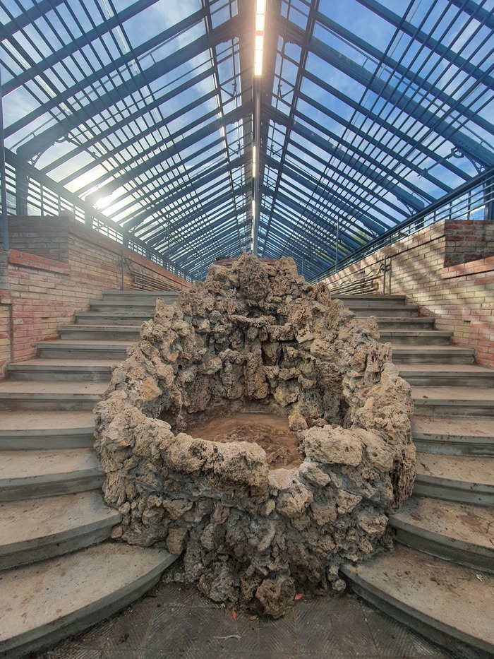 Grand escalier d'une serre de Pregny avec le mur en brique et la structure en bois et verre