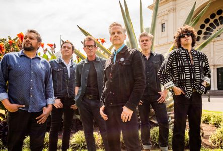 Les membres de Calexico posent avec les autres musiciens du groupe