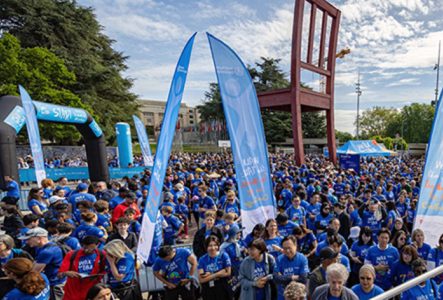 foule en bleu devant une immense chaise en bois sur une place