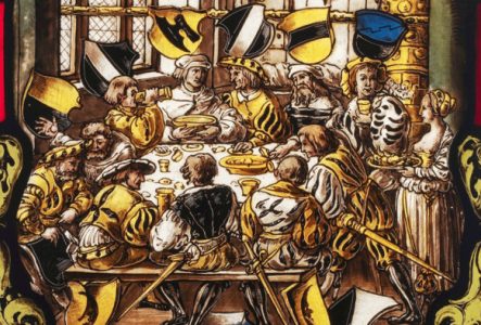 Vitrail représentant un festin médiéval : on y voit des hommes autour du table en train de manger et de boire. Il y a une dominance de jaune et de noir.