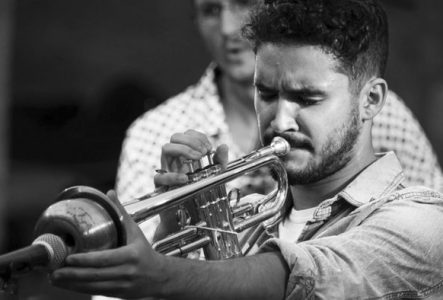 Je vois le trompettiste et un musicien du groupe derrière lui