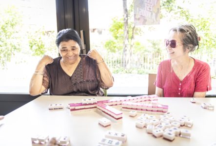 Personnes souriantes à table autour d'un jeu